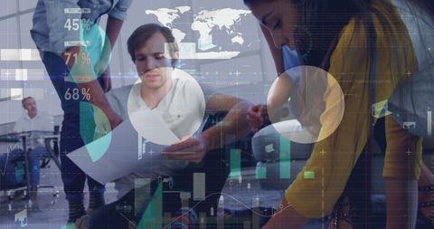 Team Collaborating with Digital Data Interfaces in Modern Office