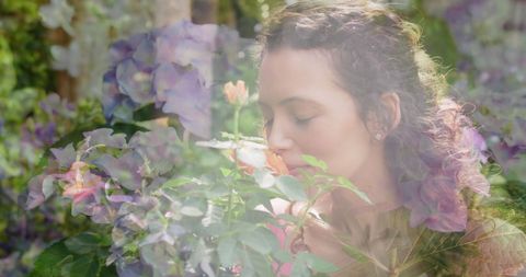 Serene Woman Enjoying Blooms in Flourishing Garden