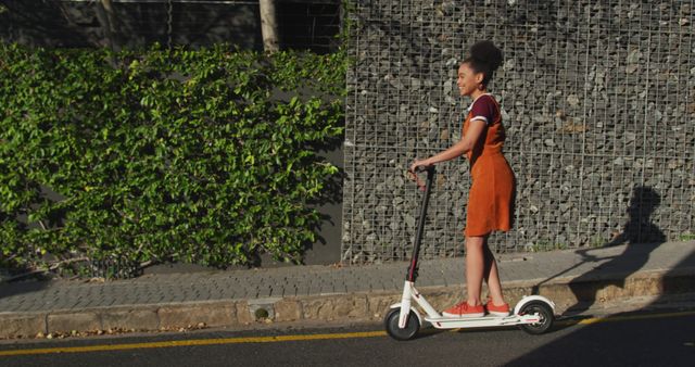 Young Woman Riding Electric Scooter on Urban Street - Download Free Stock Images Pikwizard.com