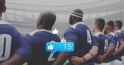 Rugby team linking arms showing thumbs-up with social likes overlay in stadium