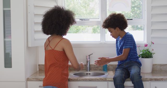 Mother and Son Washing Hands at Kitchen Sink - Download Free Stock Images Pikwizard.com