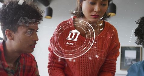 Asian professionals exploring banking hologram in modern office