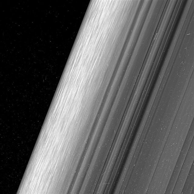 This image shows a region in Saturn's outer B ring. NASA's Cassini spacecraft viewed this area at a level of detail twice as high as it had ever been observed before.  The view here is of the outer edge of the B ring, at left, which is perturbed by the most powerful gravitational resonance in the rings: the "2:1 resonance" with the icy moon Mimas. This means that, for every single orbit of Mimas, the ring particles at this specific distance from Saturn orbit the planet twice. This results in a regular tugging force that perturbs the particles in this location.  A lot of structure is visible in the zone near the edge on the left. This is likely due to some combination of the gravity of embedded objects too small to see, or temporary clumping triggered by the action of the resonance itself. Scientists informally refer to this type of structure as "straw."  This image was taken using a fairly long exposure, causing the embedded clumps to smear into streaks as they moved in their orbits. Later Cassini orbits will bring shorter exposures of the same region, which will give researchers a better idea of what these clumps look like. But in this case, the smearing does help provide a clearer idea of how the clumps are moving.  This image is a lightly processed version, with minimal enhancement; this version preserves all original details present in the image. Another other version (Figure 1) has been processed to remove the small bright blemishes due to cosmic rays and charged particle radiation near the planet -- a more aesthetically pleasing image, but with a slight softening of the finest details.  The image was taken in visible light with the Cassini spacecraft wide-angle camera on Dec. 18, 2016. The view was obtained at a distance of approximately 32,000 miles (52,000 kilometers) from the rings and looks toward the unilluminated side of the rings. Image scale is about a quarter-mile (360 meters) per pixel.  http://photojournal.jpl.nasa.gov/catalog/PIA21057