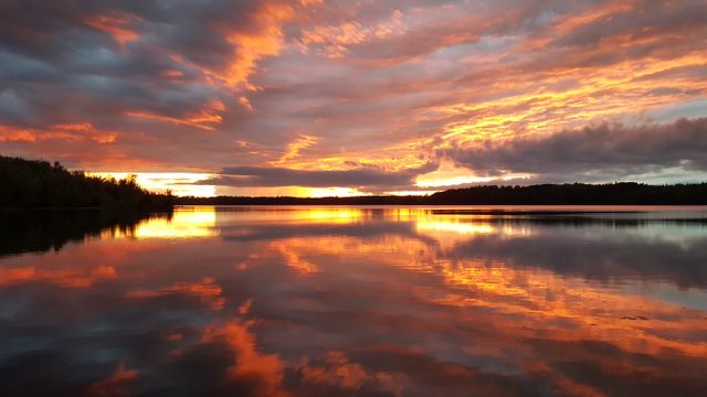 Vibrant Sunset Reflecting on Calming Lake Surface - Download Free Stock Photos Pikwizard.com