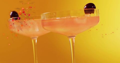 Festive Cocktails with Falling Confetti on Vibrant Background