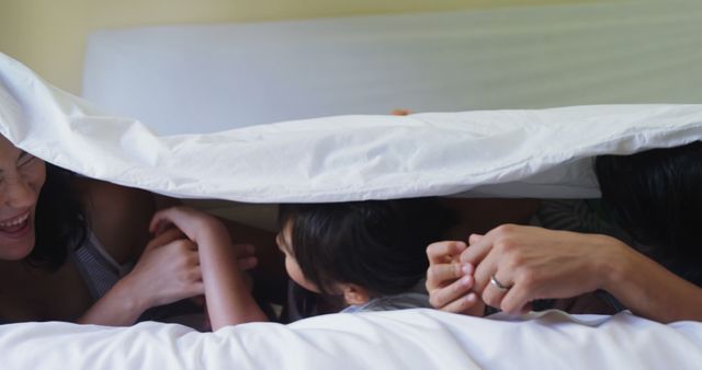 Family Bonding Under Blanket, Cuddling and Laughing in Bed - Download Free Stock Images Pikwizard.com