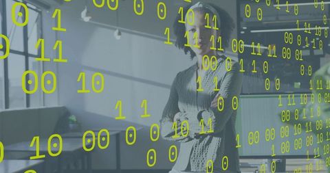 Confident woman standing in modern coworking space with neon binary data overlay