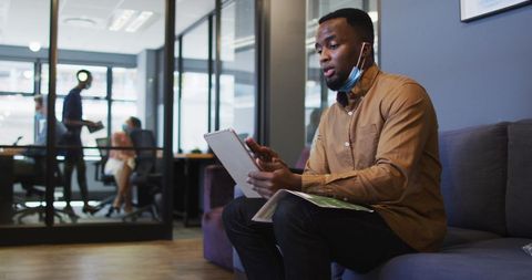 African american professional video conferencing at modern office