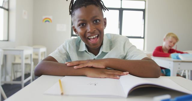 Happy Schoolboy Smiling While Studying in Classroom - Download Free Stock Images Pikwizard.com