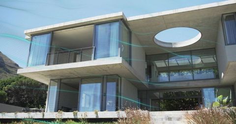 Modern concrete and glass residence featuring cantilevered slabs, circular oculus, teal mesh overlay