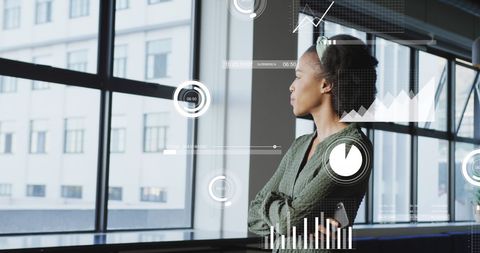 Businesswoman Analyzing Data Visuals in Modern Office Setting