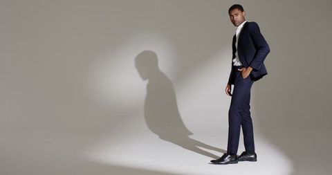 Stylish professional in suit under spotlight
