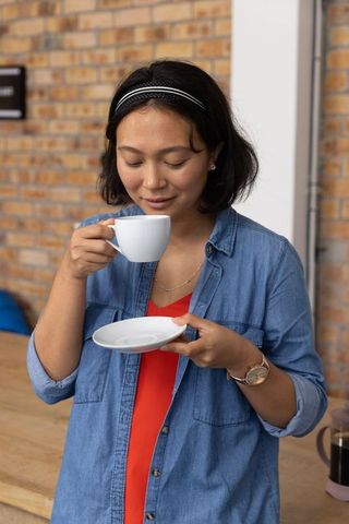 Woman enjoying coffee in urban café ambiance