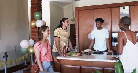 Friends Enjoying a Festive Gathering in Decorated Living Room