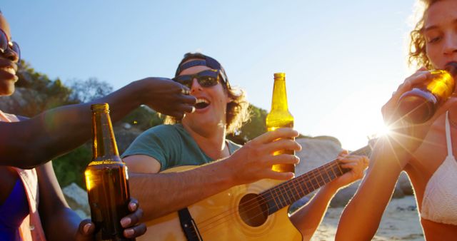 Friends Enjoying Refreshments and Music on Beach at Sunset - Download Free Stock Images Pikwizard.com