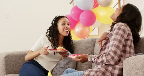 Young Women Enjoying Food and Conversation at Home