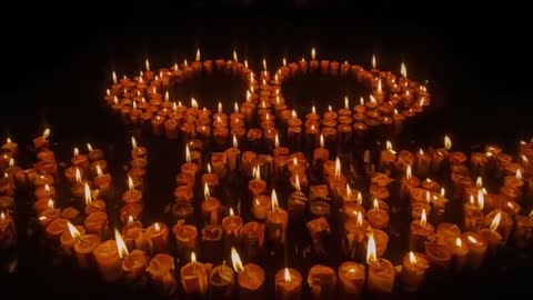 Candles Creating Tribute Message With Glistening Rings in Dark Studio