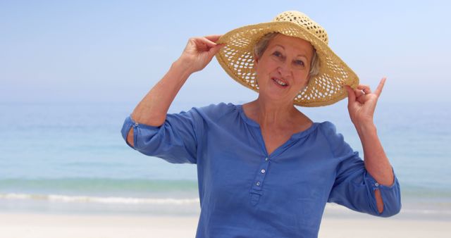 Smiling Senior Woman with Straw Hat at Seaside - Download Free Stock Images Pikwizard.com