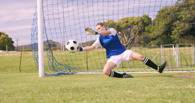 Female Soccer Goalkeeper Saving Ball in Defensive Dive - Download Free Stock Images Pikwizard.com