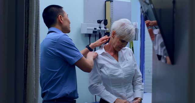 An elderly woman is receiving a chiropractic adjustment from a healthcare professional in a clinical setting. This image is suitable for use in healthcare, wellness, senior care, and physiotherapy-related content. It can illustrate topics on manual therapy, back pain relief, and senior health care services.