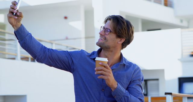 Smiling Man Taking Selfie Holding Coffee Cup Outside Modern Building - Download Free Stock Images Pikwizard.com