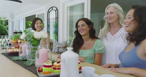 Friends Gathering for Brunch on Sunny Patio Sharing Laughter