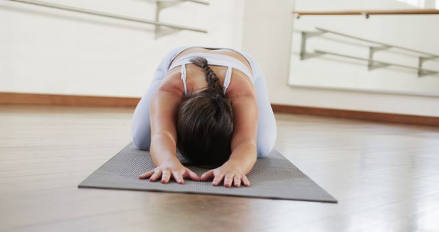 Woman Practicing Yoga in Child's Pose on Mat in Studio - Download Free Stock Images Pikwizard.com