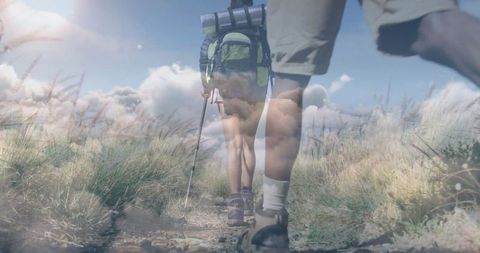 Adventurous hikers trekking scenic mountain path on cloudy day