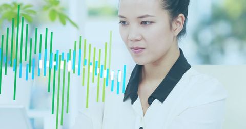 Asian Businesswoman Analyzing Financial Data Visualization