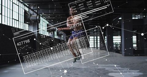 Jumping athlete in industrial warehouse with futuristic hud data overlay and motion