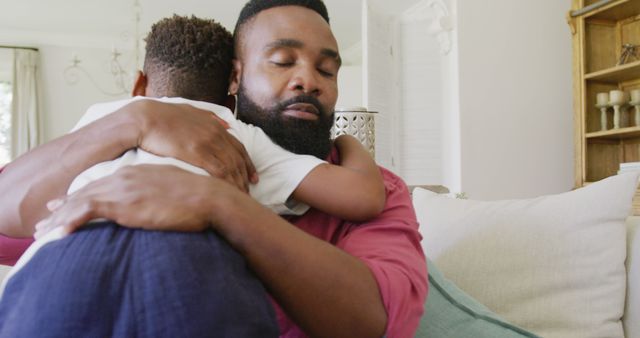 Loving Father Hugging Young Child in Cozy Living Room - Download Free Stock Images Pikwizard.com