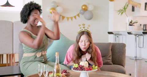 Portrait of multicultural couple celebrating birthday at home