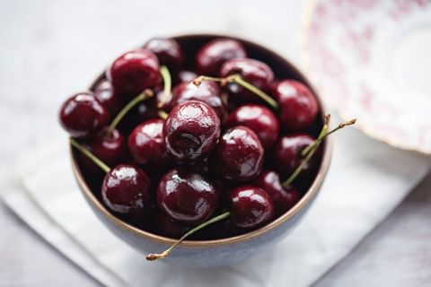 Fresh cherry background in bowl on light table setting