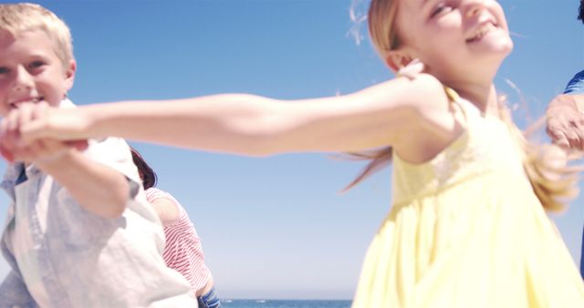 Joyful Children Holding Hands at Beach on Sunny Day - Download Free Stock Images Pikwizard.com