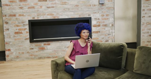 Woman with Blue Hair Talking on Phone and Working on Laptop at Home - Download Free Stock Images Pikwizard.com