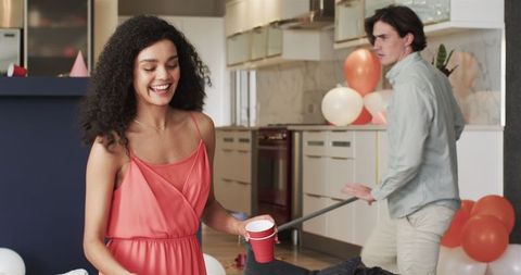 Couple Cleaning Up After Party in Modern Living Room