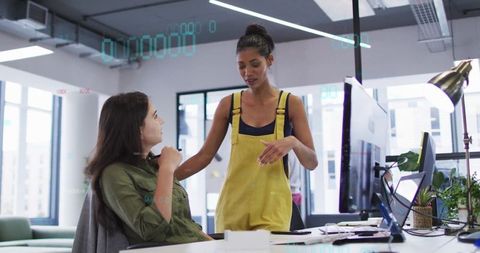 Collaborative Discussion Between Coworkers in Modern Open-Plan Office