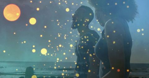 Romantic Couple Watching Ocean at Sunset with Magical Lights