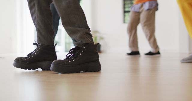 Unrecognizable people dancing indoors wearing casual clothing and boots - Download Free Stock Images Pikwizard.com