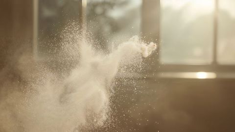 Swirling milk powder particles in gentle sunlight