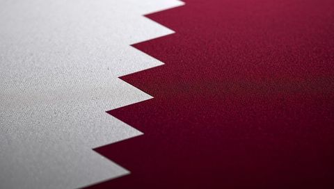 Macro textile close-up of qatar flag serrated edge showing woven fabric texture