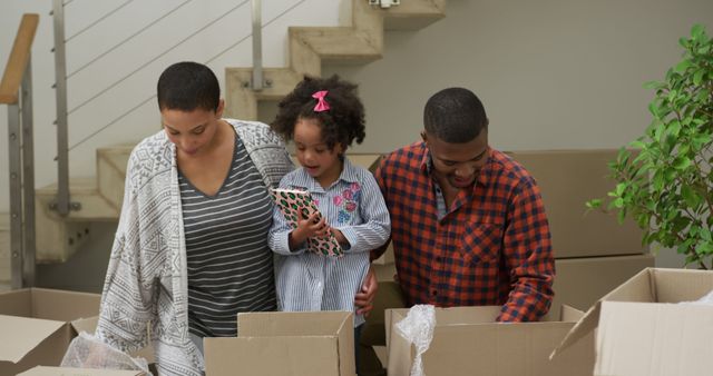 Happy African American Family Unpacking in New Home - Download Free Stock Images Pikwizard.com