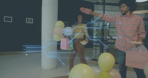 Coworkers walking and carrying balloons and pink gift bags in office lobby with holographic overlay