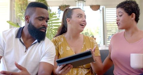 Diverse Friends Sharing Tablet and Discussing Technology Insights