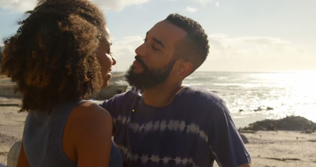 Romantic diverse couple standing, embracing and smiling on sunny beach, copy space - Download Free Stock Photos Pikwizard.com