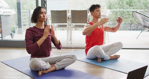 Diverse Couple Meditating Together at Home