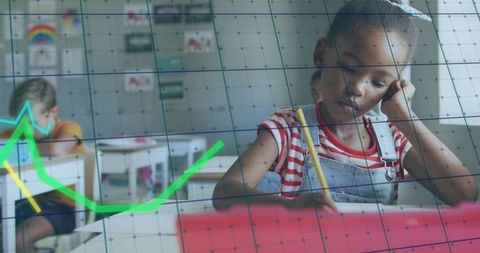 Focused schoolgirl writing at desk with tablet, classroom learning and infographic overlay