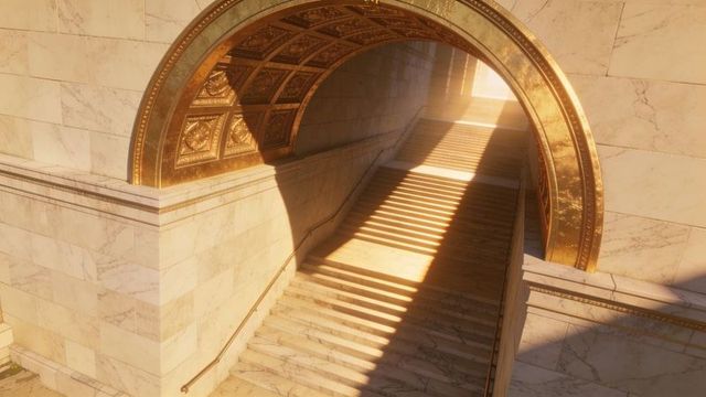 Sunlit marble staircase leading through gilded arched vault in neoclassical interior