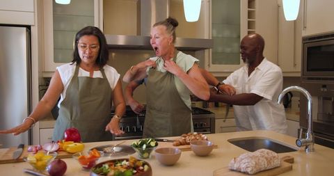 Group culinary adventure: diverse friends cooking together with joy