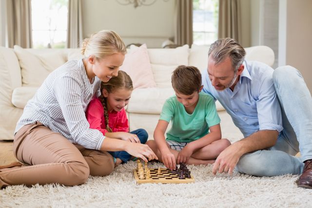 Family playing chess together at home in the living room at home